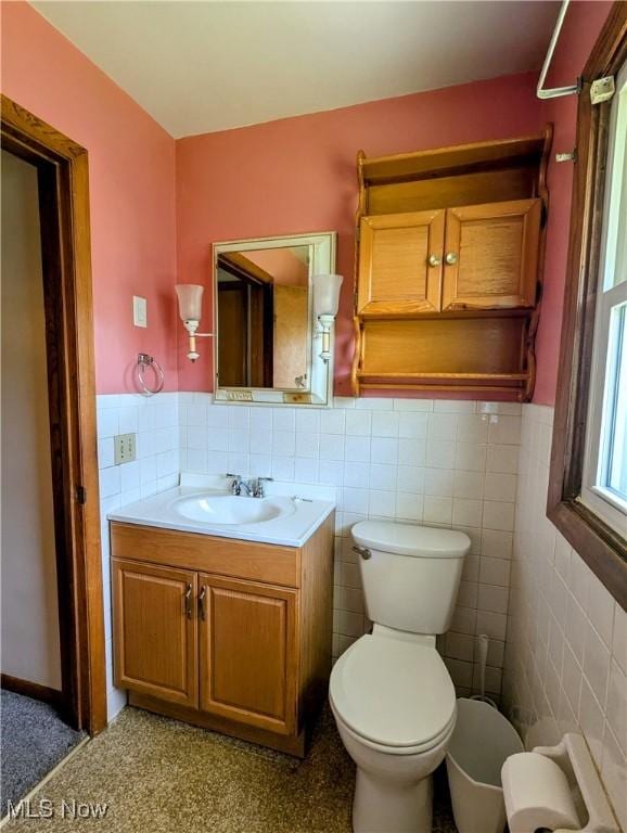 316 S Inglewood Ave, Austintown, OH 44515 - bathroom featuring wainscoting, tile walls, toilet, and vanity