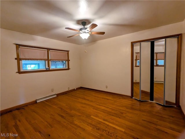 316 S Inglewood Ave, Austintown, OH 44515 - unfurnished room featuring baseboard heating, a ceiling fan, dark wood-style flooring, and baseboards