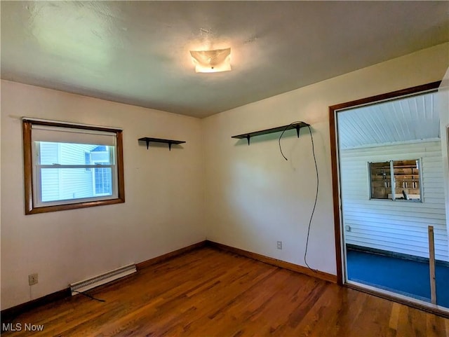 316 S Inglewood Ave, Austintown, OH 44515 - spare room with a baseboard heating unit, baseboards, and wood finished floors