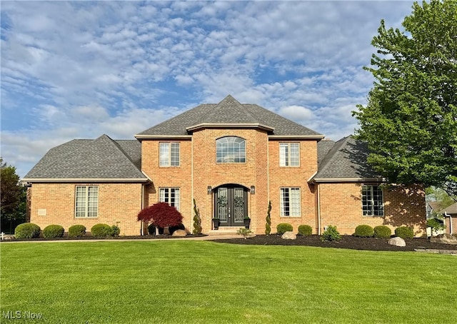 3995 Montereale Dr, Canfield, OH 44406 - view of front of house featuring a front yard, brick siding, and french doors