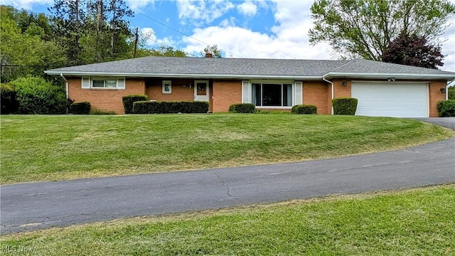 6291 Veterans Blvd, Chester, WV 26034 - ranch-style home featuring an attached garage, asphalt driveway, brick siding, and a front yard