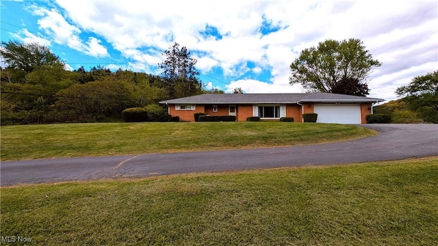 6291 Veterans Blvd, Chester, WV 26034 - single story home with a garage, driveway, a front lawn, and brick siding