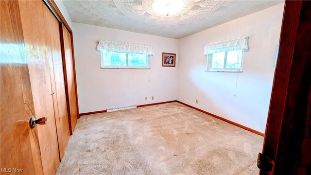 6291 Veterans Blvd, Chester, WV 26034 - unfurnished bedroom with multiple windows, carpet floors, a closet, and baseboards