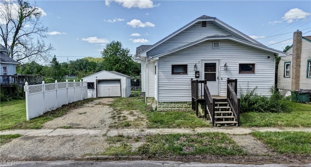 17 Spring St, Dennison, OH 44621 - shotgun-style home featuring fence, an outdoor structure, driveway, and a garage