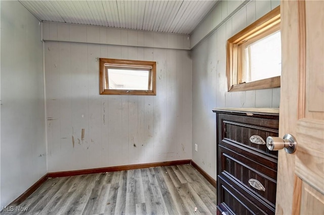 17 Spring St, Dennison, OH 44621 - spare room featuring wood finished floors, baseboards, and wooden walls