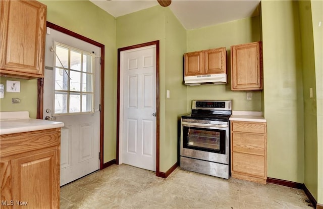 17 Spring St, Dennison, OH 44621 - kitchen with electric stove, under cabinet range hood, light countertops, and baseboards