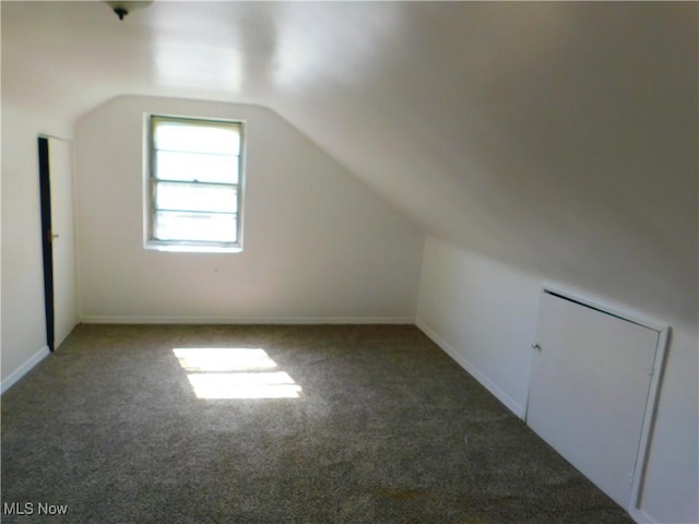 bonus room featuring carpet flooring and vaulted ceiling