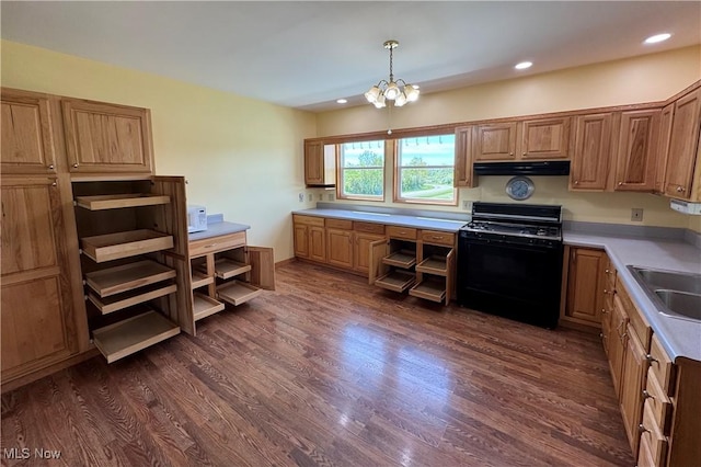6255 Highland Ridge Rd, Lowell, OH 45744 - kitchen with black range with gas stovetop, under cabinet range hood, dark wood-style floors, a sink, and light countertops