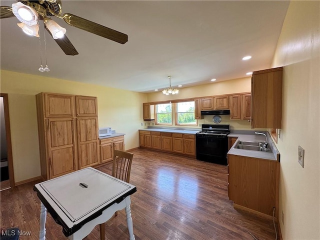 6255 Highland Ridge Rd, Lowell, OH 45744 - kitchen featuring black range with gas stovetop, a sink, under cabinet range hood, white microwave, and a ceiling fan