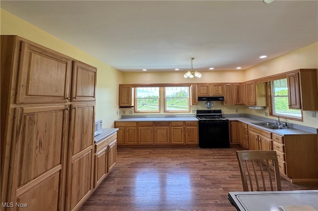 6255 Highland Ridge Rd, Lowell, OH 45744 - kitchen with black range with gas cooktop, a sink, under cabinet range hood, dark wood-style floors, and a chandelier