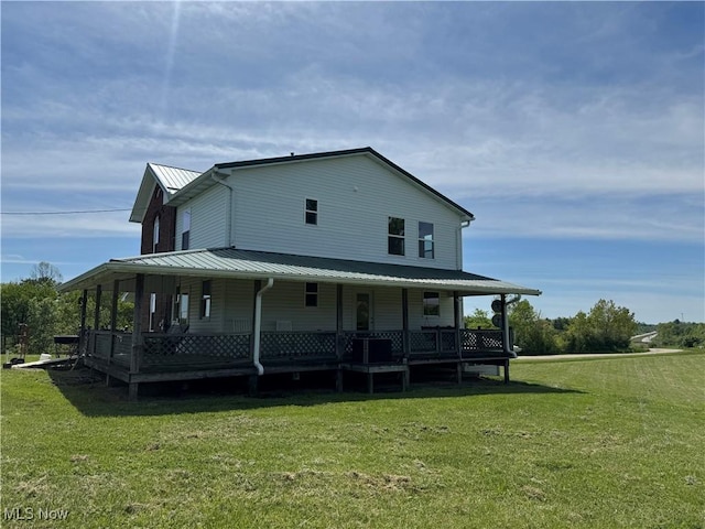 6255 Highland Ridge Rd, Lowell, OH 45744 - back of house with covered porch, a yard, and metal roof