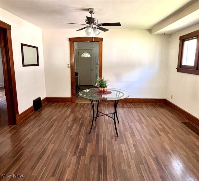 unfurnished dining area with baseboards, wood finished floors, and ceiling fan