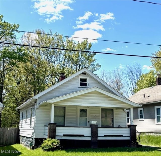 view of front facade with a porch and a chimney