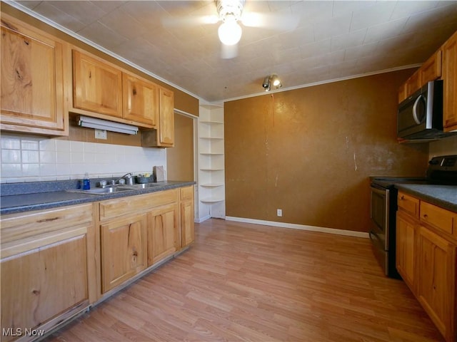 111 Pine Ln, Barnesville, OH 43713 - kitchen featuring stainless steel appliances, dark countertops, light wood-type flooring, ornamental molding, and a sink
