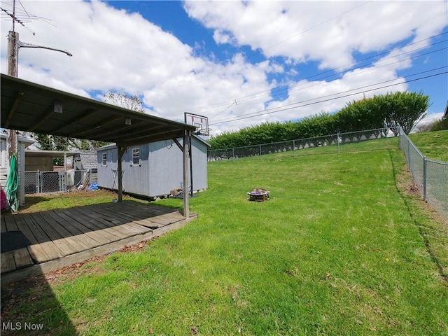 111 Pine Ln, Barnesville, OH 43713 - view of yard with a storage unit, an outdoor fire pit, a deck, and an outdoor structure