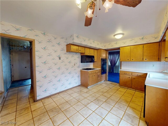 1930 Aldersgate Dr, Lyndhurst, OH 44124 - kitchen featuring black appliances, a sink, wallpapered walls, light countertops, and a ceiling fan