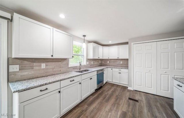 1527 Carterland Dr, Ashtabula, OH 44004 - kitchen with stainless steel dishwasher, a sink, dark wood-style floors, white cabinets, and decorative backsplash