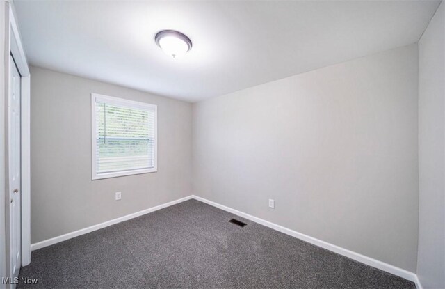 1527 Carterland Dr, Ashtabula, OH 44004 - empty room with dark carpet and baseboards