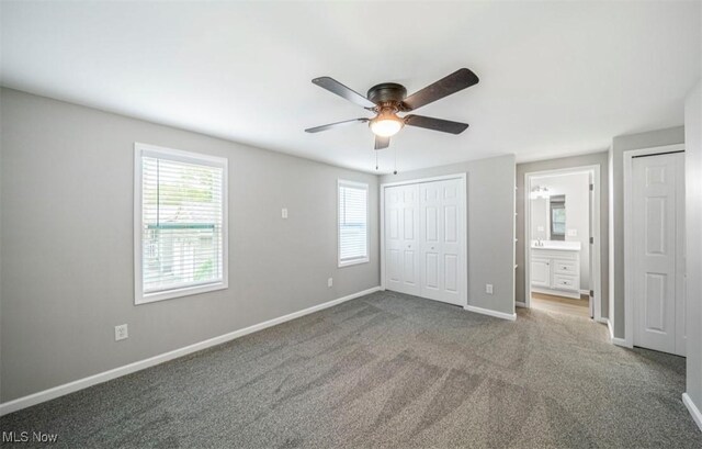 1527 Carterland Dr, Ashtabula, OH 44004 - unfurnished bedroom with multiple windows, baseboards, and multiple closets