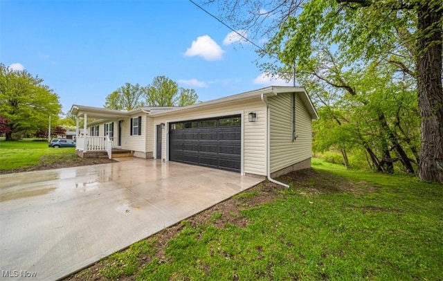 1527 Carterland Dr, Ashtabula, OH 44004 - view of front of home with an attached garage, concrete driveway, a front lawn, and covered porch