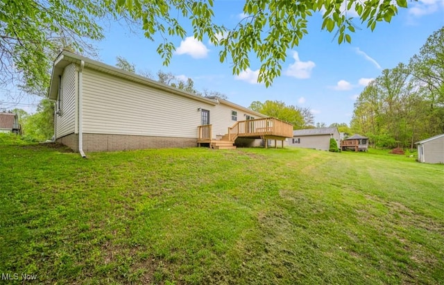 1527 Carterland Dr, Ashtabula, OH 44004 - rear view of house with a deck and a lawn