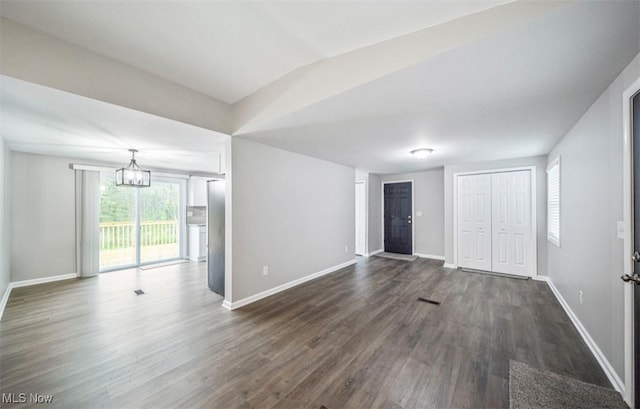 1527 Carterland Dr, Ashtabula, OH 44004 - unfurnished living room featuring dark wood-style flooring, baseboards, and a chandelier