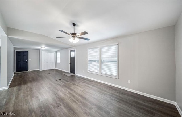 1527 Carterland Dr, Ashtabula, OH 44004 - unfurnished living room with baseboards, dark wood-style flooring, ceiling fan, and vaulted ceiling