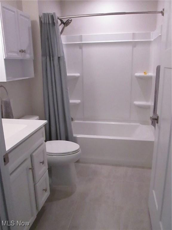bathroom featuring tile patterned floors, toilet, shower / bath combination with curtain, and vanity