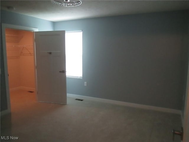 carpeted spare room with baseboards