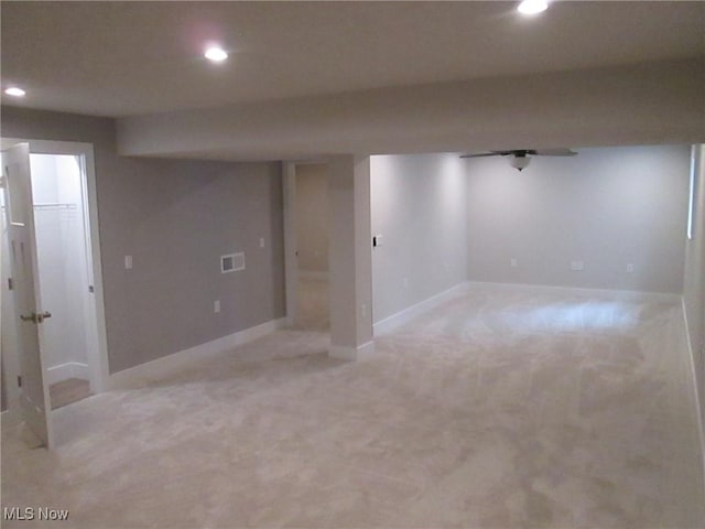 finished below grade area with recessed lighting, light colored carpet, and baseboards