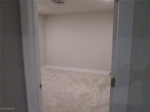 carpeted empty room with baseboards