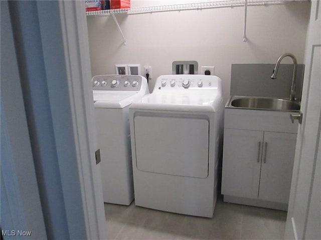 laundry room with independent washer and dryer and cabinet space