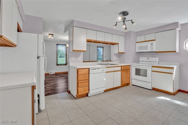 2000 Henry Ave SW, Canton, OH 44706 - kitchen featuring white appliances, a sink, light countertops, baseboards, and light tile patterned floors