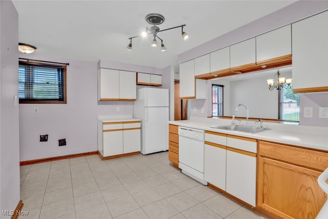 2000 Henry Ave SW, Canton, OH 44706 - kitchen featuring white appliances, a sink, a chandelier, light countertops, and white cabinetry