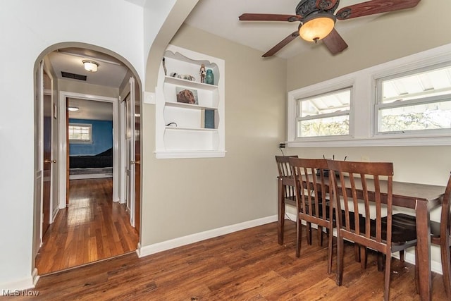 7101 Reynolds Rd, Mentor, OH 44060 - dining space with arched walkways, wood finished floors, ceiling fan, and baseboards
