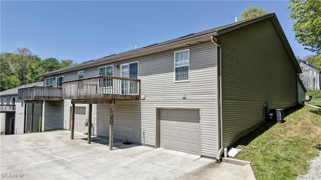 213 Knollton Dr, Millersburg, OH 44654 - view of front of property with an attached garage, concrete driveway, a balcony, and central AC
