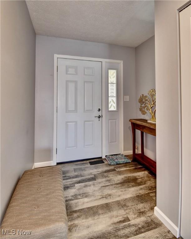 213 Knollton Dr, Millersburg, OH 44654 - entryway with baseboards and a textured ceiling