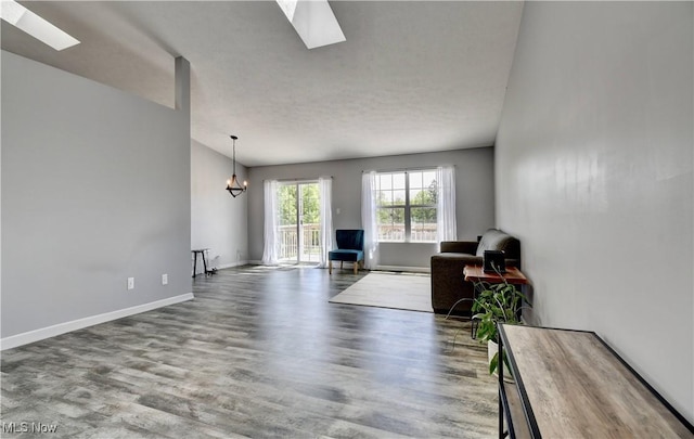 213 Knollton Dr, Millersburg, OH 44654 - living area with a skylight, wood finished floors, a chandelier, and baseboards