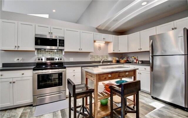 213 Knollton Dr, Millersburg, OH 44654 - kitchen featuring stainless steel appliances, light wood-type flooring, a sink, white cabinets, and recessed lighting