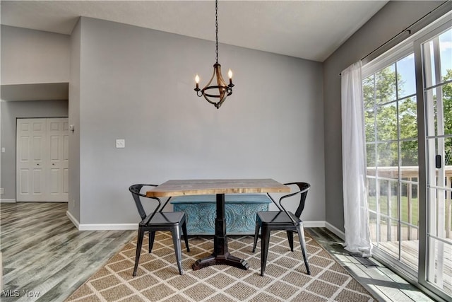 213 Knollton Dr, Millersburg, OH 44654 - dining space featuring baseboards, wood finished floors, a chandelier, breakfast area, and lofted ceiling
