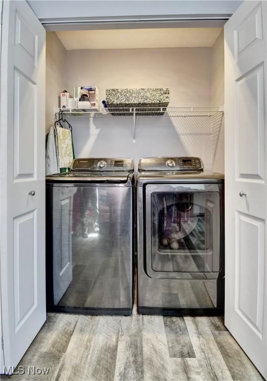 213 Knollton Dr, Millersburg, OH 44654 - washroom featuring washing machine and dryer and wood finished floors