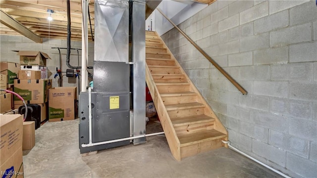 213 Knollton Dr, Millersburg, OH 44654 - unfinished below grade area featuring concrete block wall, stairway, and heating unit