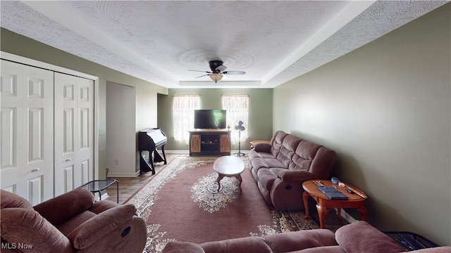 333 Mulberry St, Barnesville, OH 43713 - living area featuring a ceiling fan, a raised ceiling, baseboards, and wood finished floors