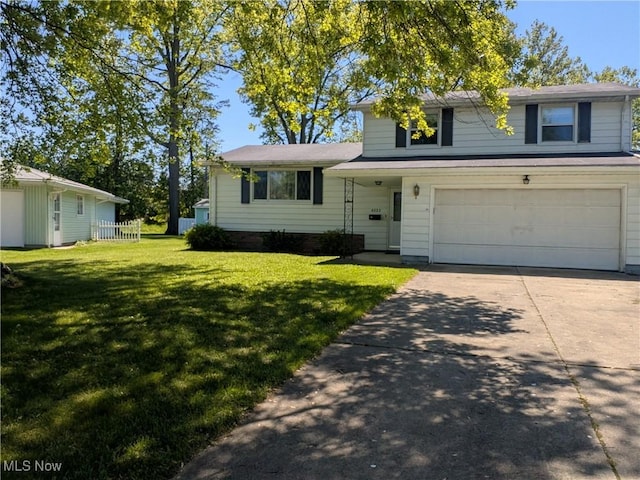 4222 Kenyon Ct, Lorain, OH 44053 - split level home featuring an attached garage, concrete driveway, and a front yard