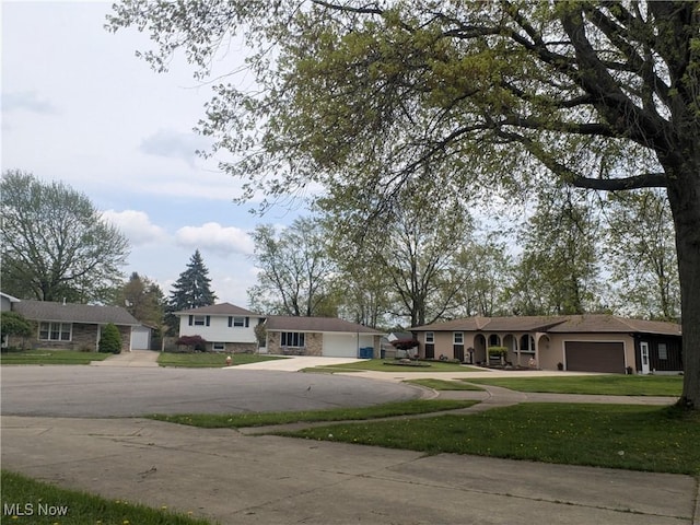 4222 Kenyon Ct, Lorain, OH 44053 - tri-level home with driveway, a front yard, a garage, and a residential view