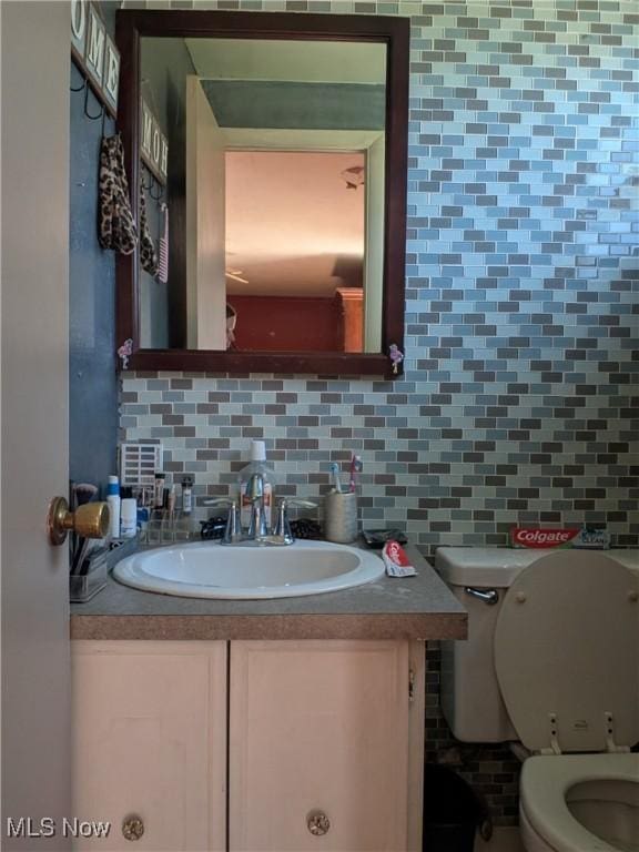 4222 Kenyon Ct, Lorain, OH 44053 - half bathroom featuring decorative backsplash, toilet, and vanity