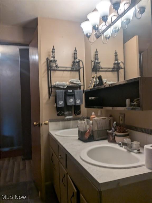 4222 Kenyon Ct, Lorain, OH 44053 - bathroom with double vanity and a chandelier