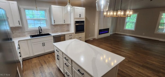 1404 15th St, Vienna, WV 26105 - kitchen featuring appliances with stainless steel finishes, dark wood-style floors, white cabinets, and tasteful backsplash