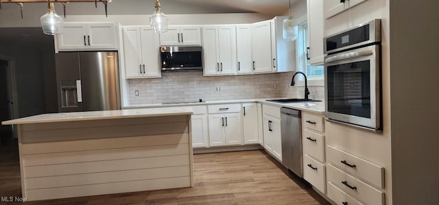 1404 15th St, Vienna, WV 26105 - kitchen featuring appliances with stainless steel finishes, light countertops, white cabinets, and pendant lighting