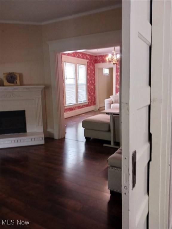 636 4th St, Marietta, OH 45750 - living area featuring wood finished floors, baseboards, ornamental molding, a fireplace, and wallpapered walls